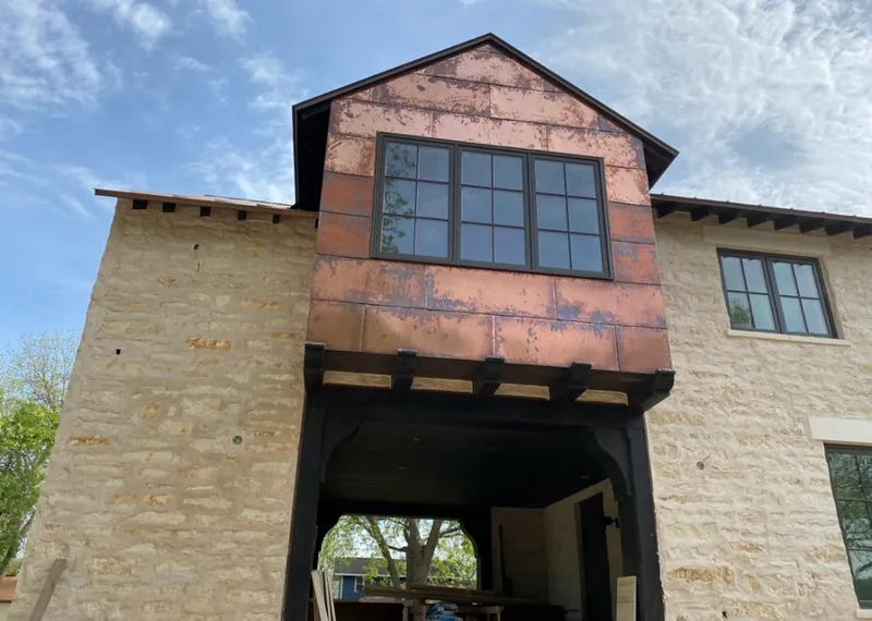 Copper metal panel facade on a stone building for Metal Roof Coating in Murray